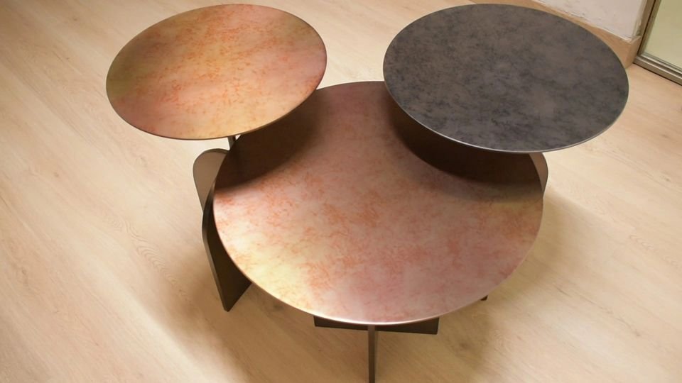 Overlapping round tables in patinated finishes