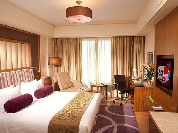 Hotel guest room with panelled headboard and writing desk