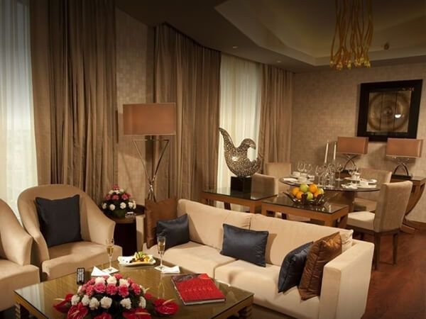 Suite living room with lounge seating and dining