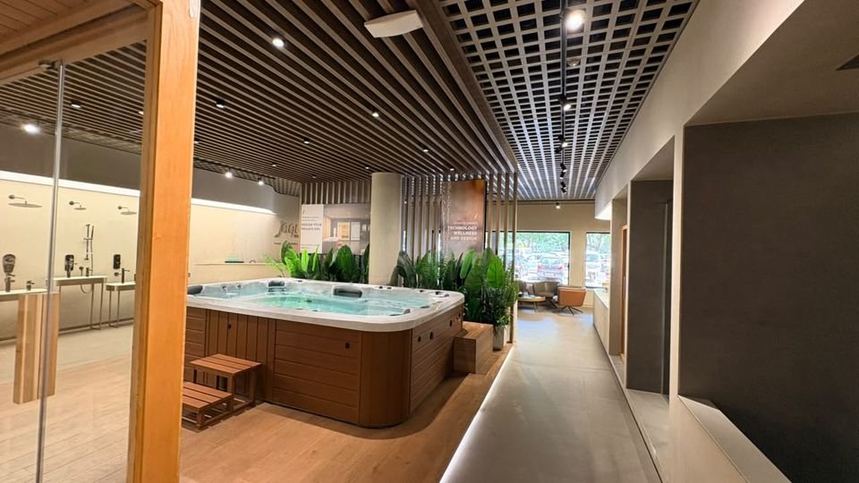 Spa pool in timber surround. A spa pool framed by timber decking, planting and glass, seen from the adjoining corridor.