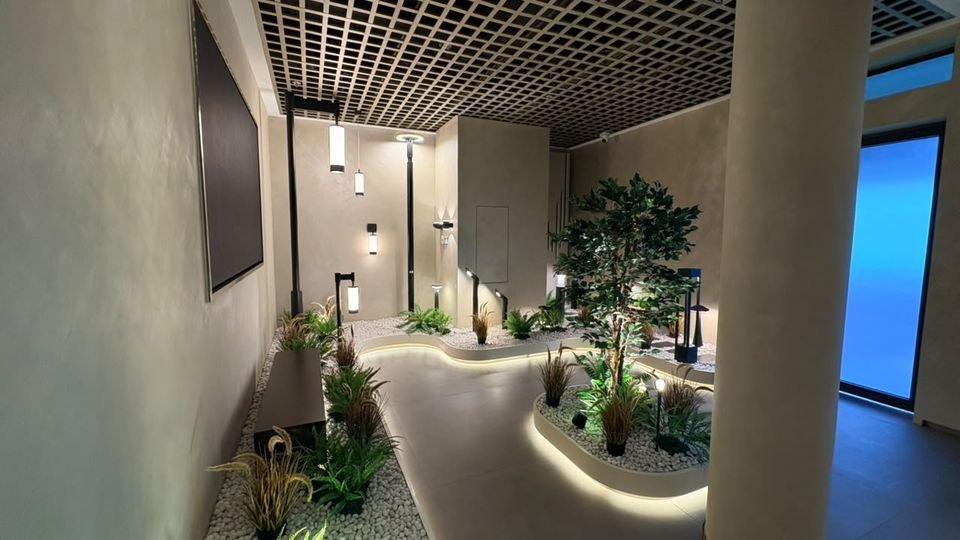 Outdoor lighting walk. A path through planted beds lit by bollards, pole lights and step lights.