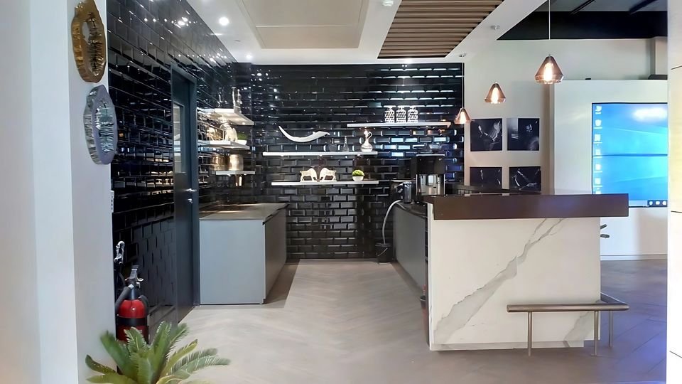 Pantry with black metro tiles and a marble-look counter